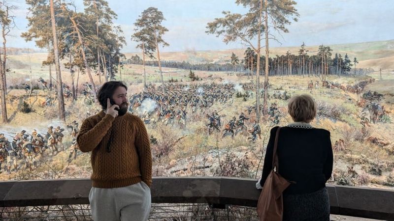 Standing at the rail of the Racławice Panorama, a vast circular painting of an 18th-century battle